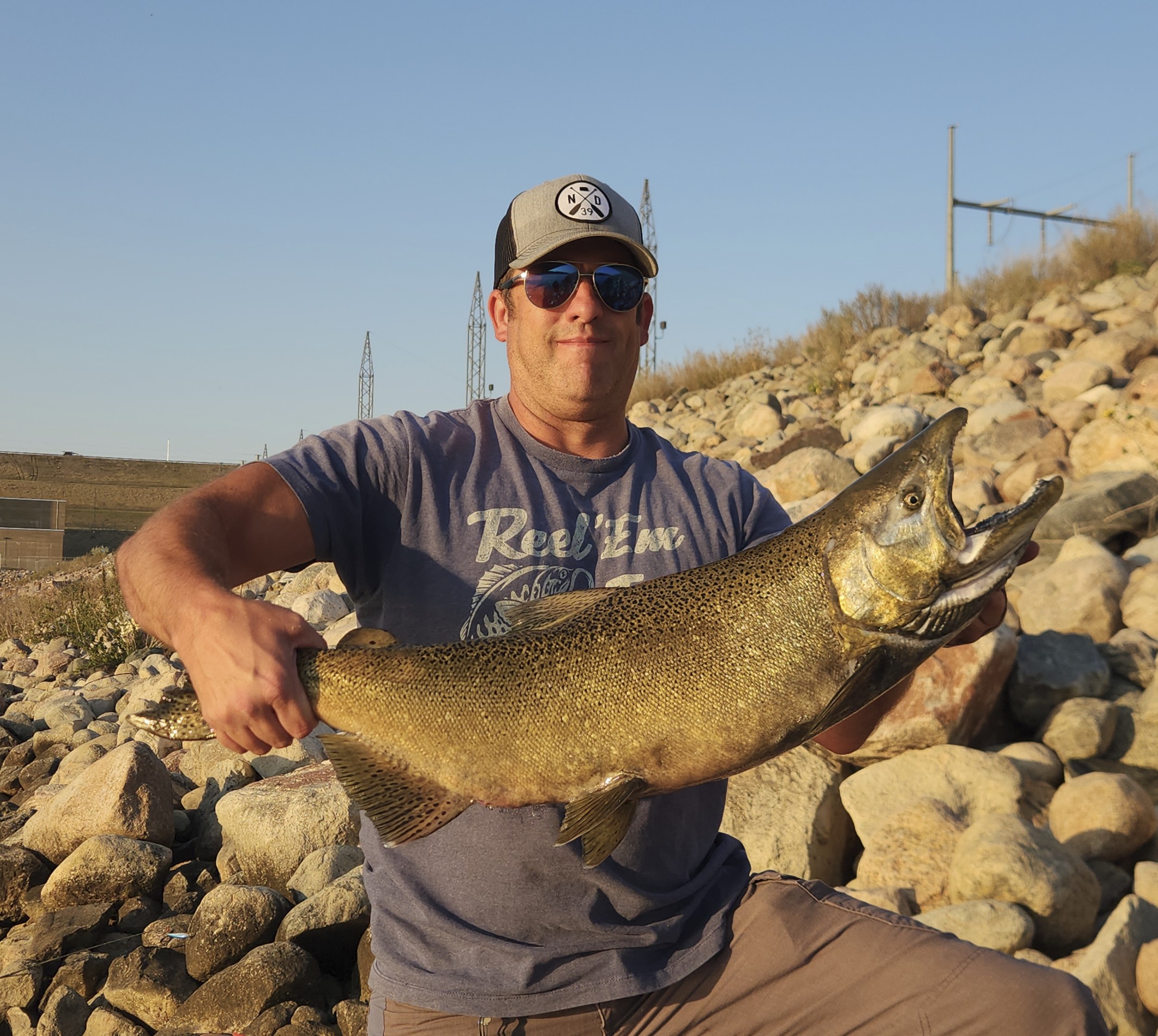 Scott, founder of Elevated Fishing, holding a chinook salmon on a North Dakota tailrace
